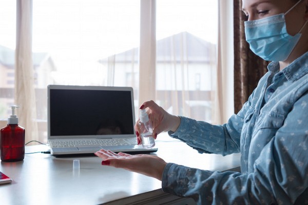 young woman face mask disinfecting gadgets surfaces her workplace 155003 4372